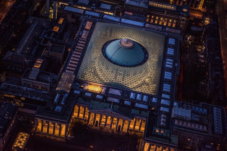 an aerial view of the British Museum at night with heist vibes