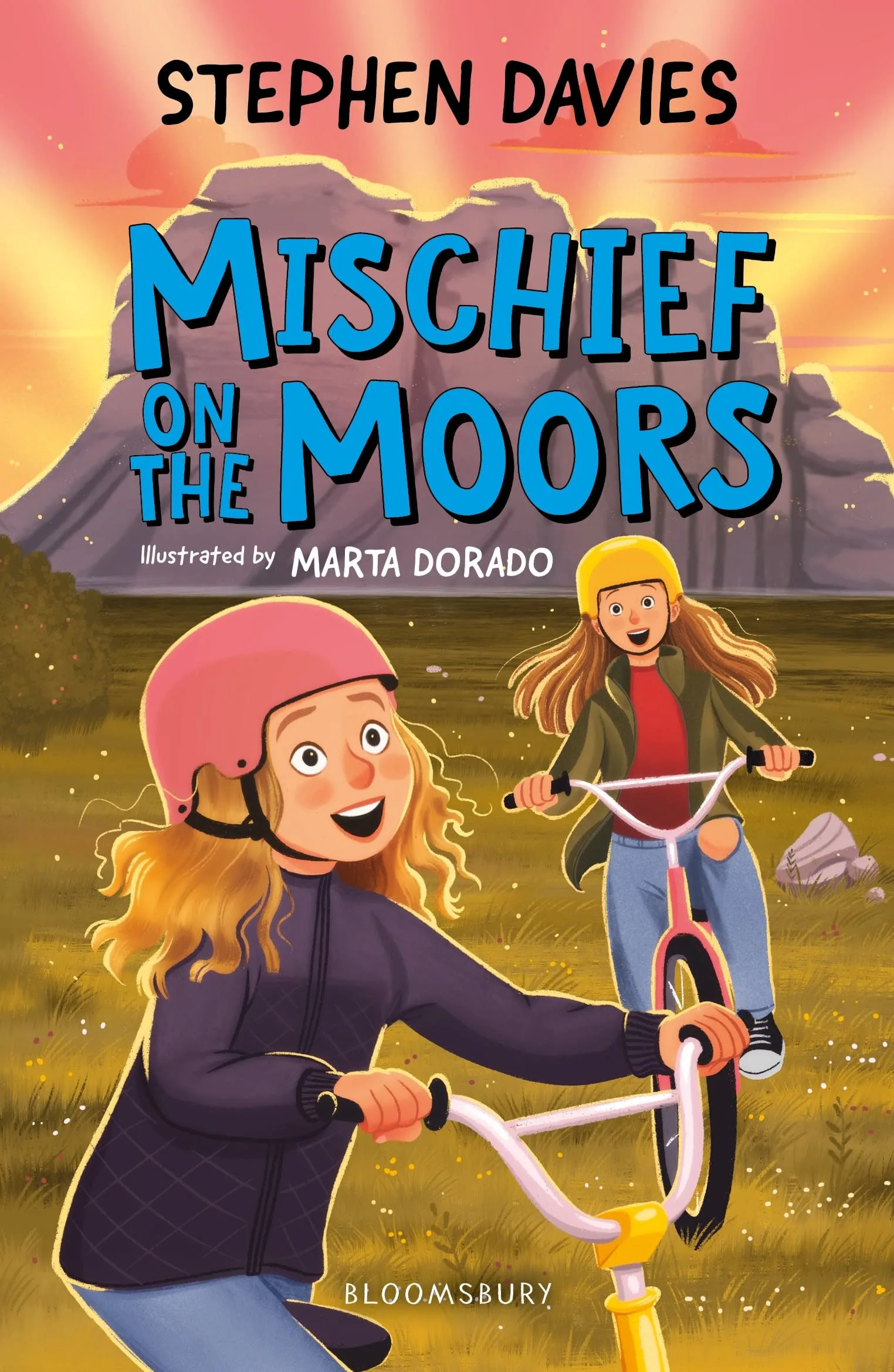 Front cover of Mischief on the Moors by Stephen Davies: two cartoon girls riding their BMX bikes in front of Hay Tor, Dartmoor