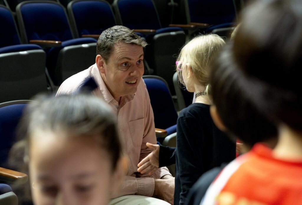 Stephen Davies talking with an international school pupil