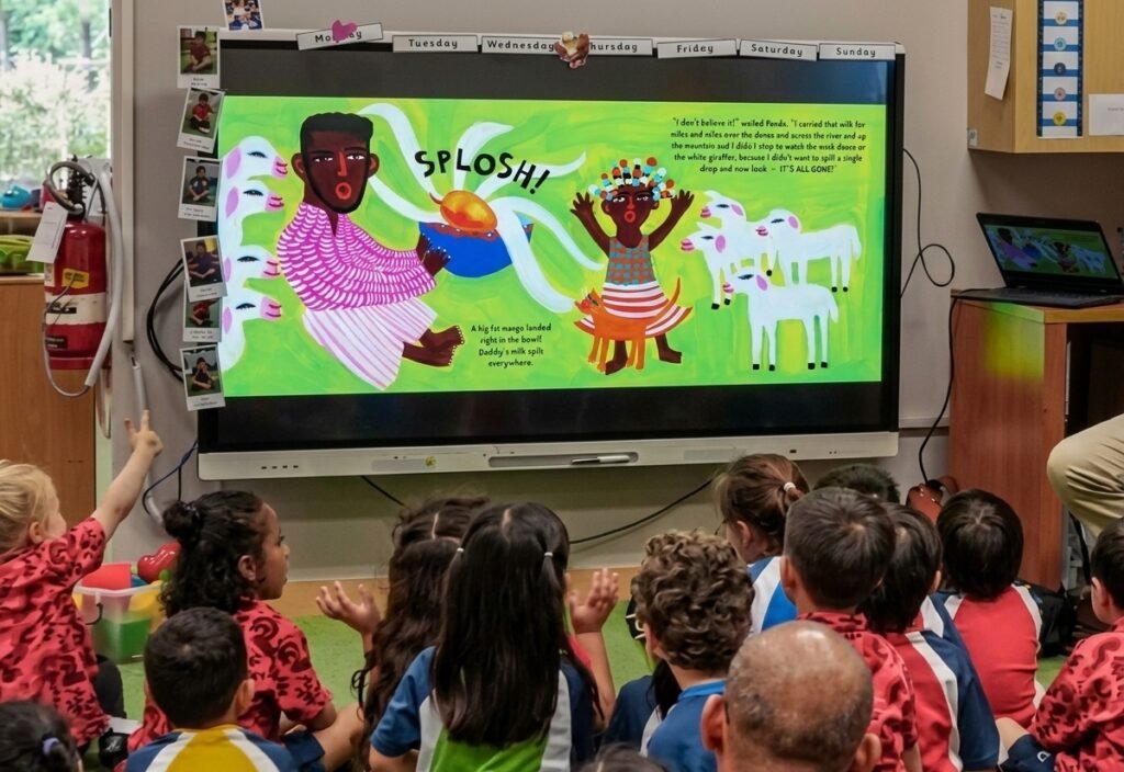 A class of children reading Don't Spill the Milk on an interactive whiteboard