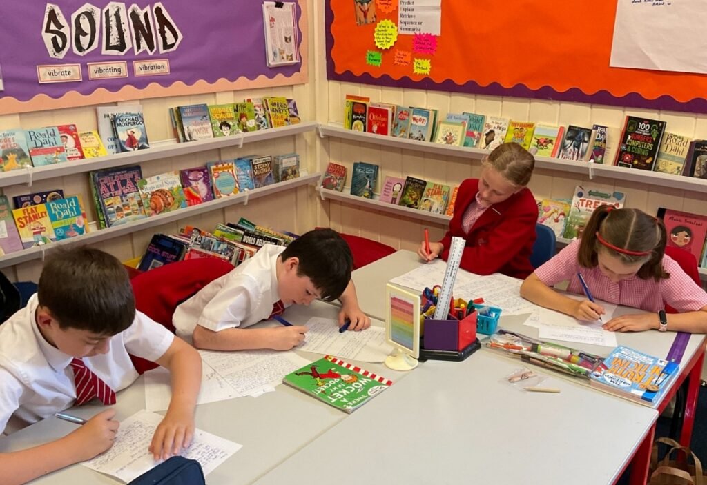 children writing at an AIM High writing day